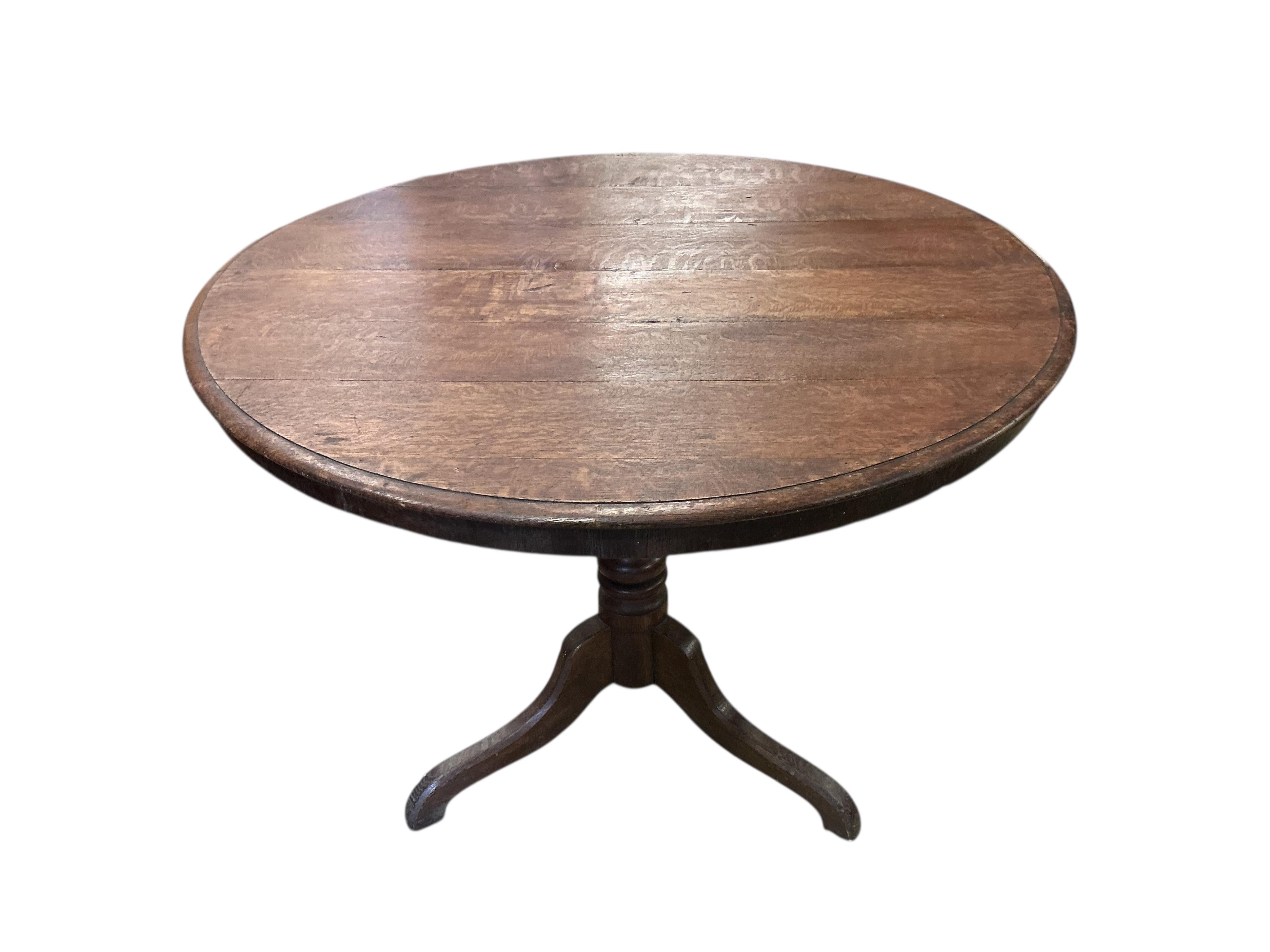 A 19th century circular oak tilt top tripod breakfast table, diameter 97cm, height 74cm